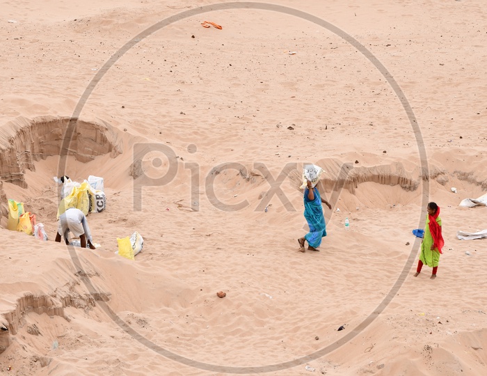 Indian Women carrying sand on her head