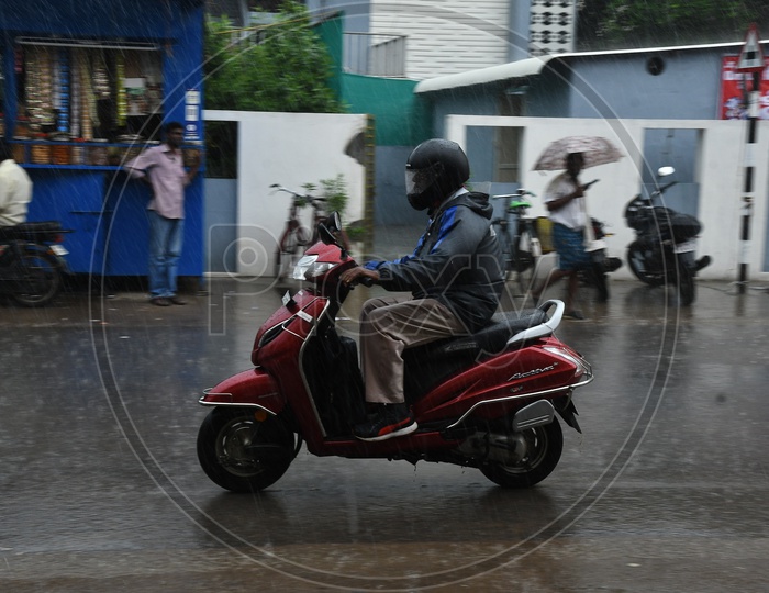 Bike Commuter Riding in Rain on Urban City Roads