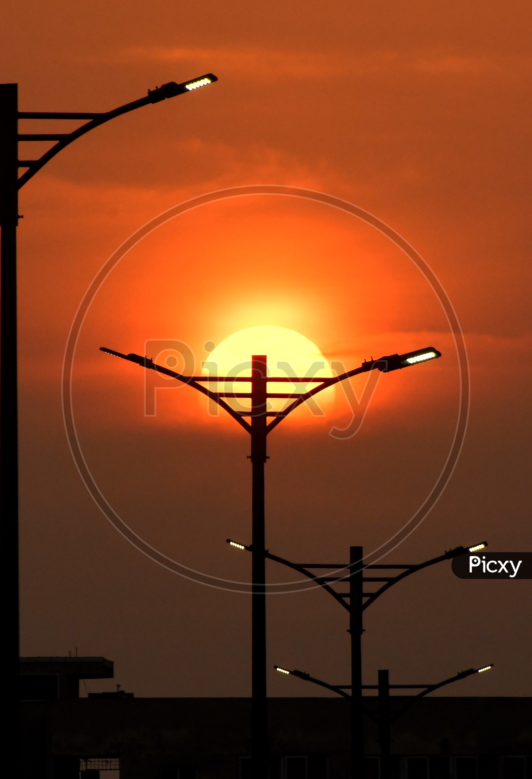 Silhouette of street lights during sunset