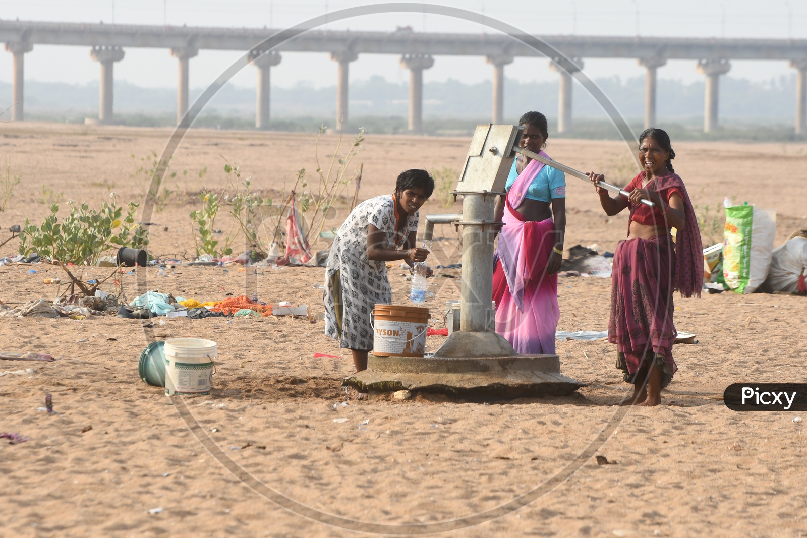 Indian Rural People pumping water from borewell