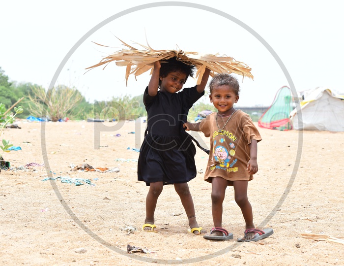 Indian Rural kids playing with a palm tree leaf