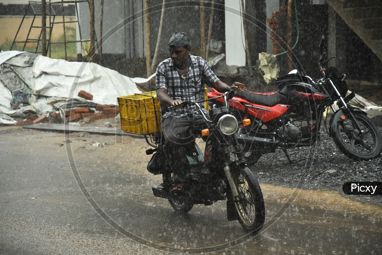 Bike Commuter Riding in Rain on Urban City Roads
