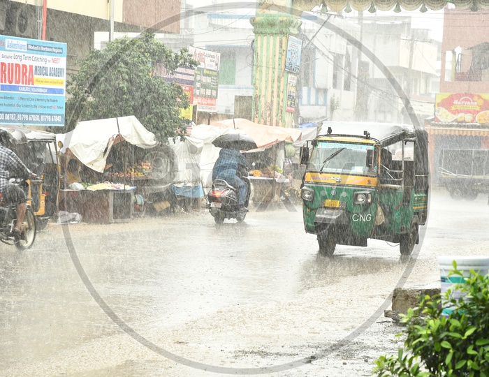 CNG Auto Running On Roads In Heavy Rain