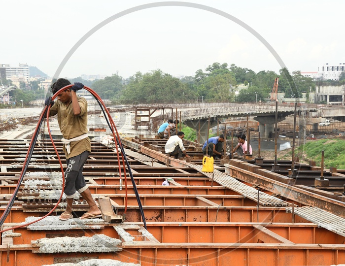 Construction Workers Working at a New Flyover Construction Site in Vijayawada