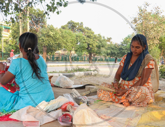 Indian Woman Preparing  Handmade Or Hand Weaved Baskets in a Road Side Vendor Stall