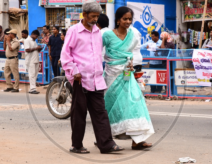 Indian Elderly couple walking on the road
