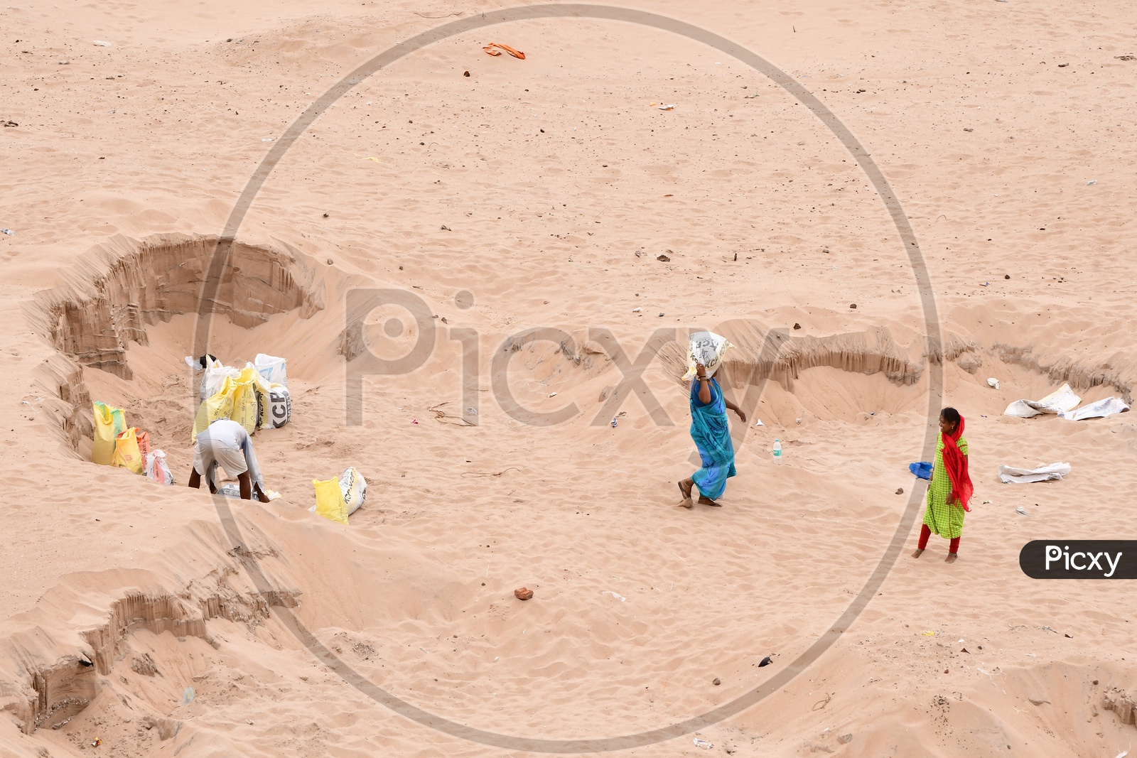 Indian Women carrying sand on her head