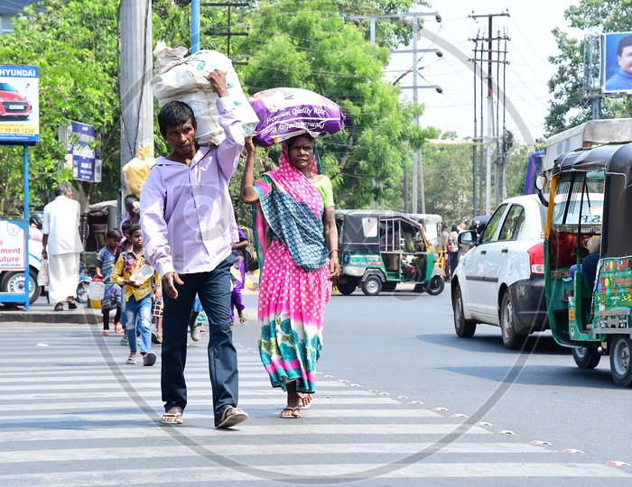 Indian People carrying load on their shoulders