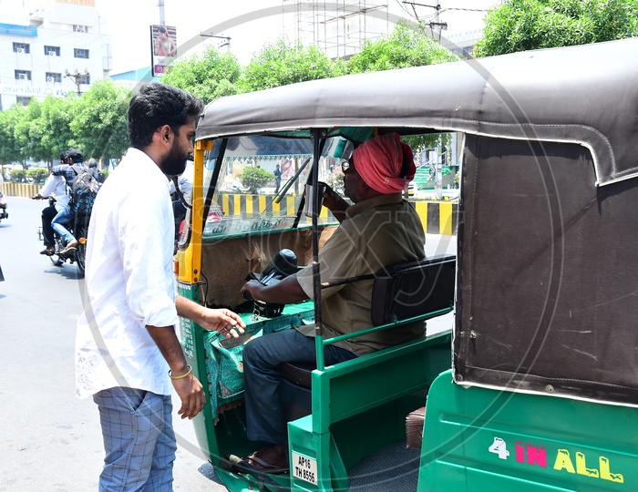 Indian Man giving Buttermilk to the Auto Driver