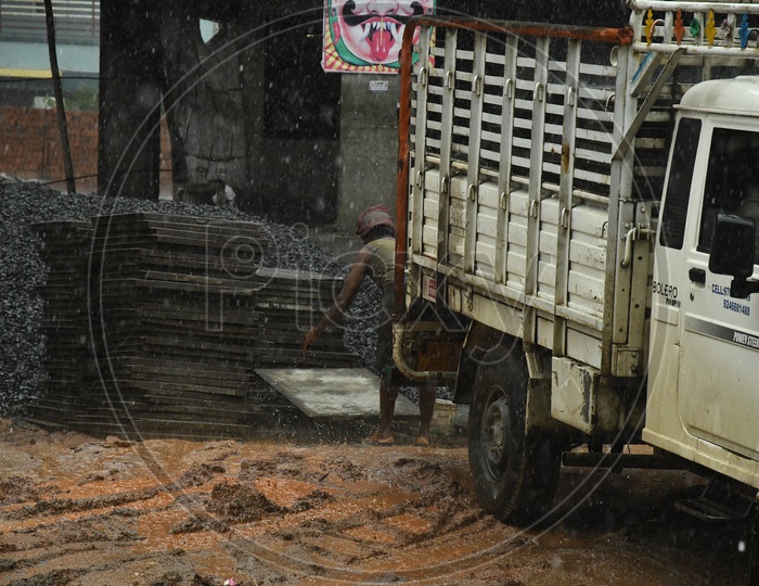 A Construction Worker Working In Heavy Rain