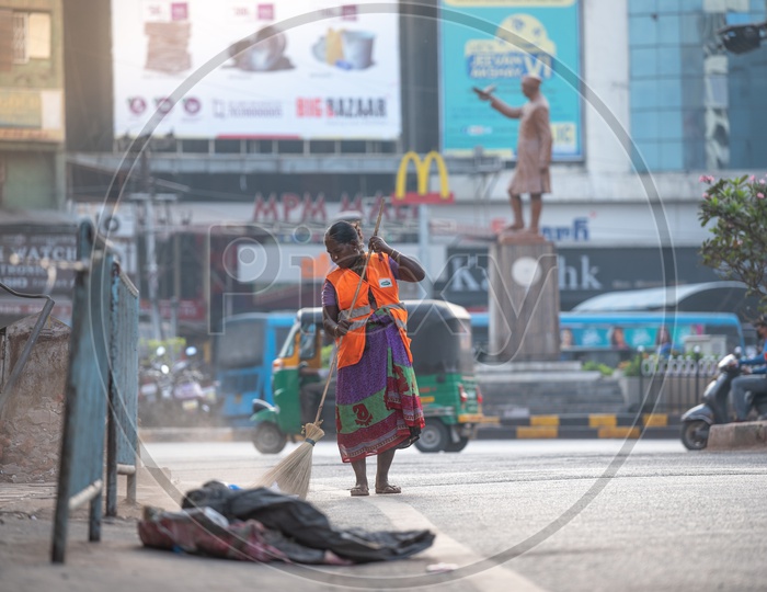 A Ghmc worker cleans road early in the morning