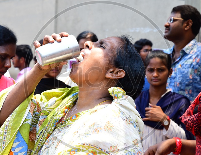 Indian Woman drinking Buttermilk during summer