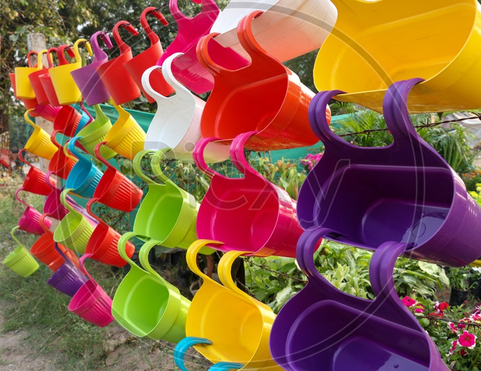 Colorful Hanging Flower Pots Being Selling at a Road side Vendor Stall