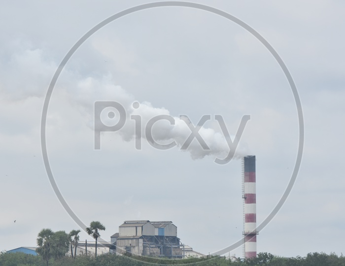Thick Smoke Of an Industrial Pollution From an Exhaust Pipe over Sky Background