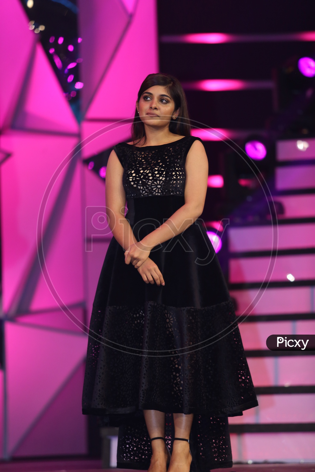 Tollywood Actress Nivetha Thomas standing on the stage