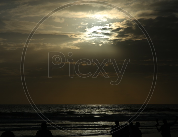 Silhouette of People In a Beach With Sunset Sky
