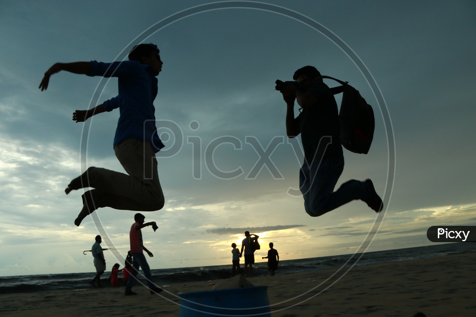 Silhouette Of a Photographer Jumping While Clicking In a Beach