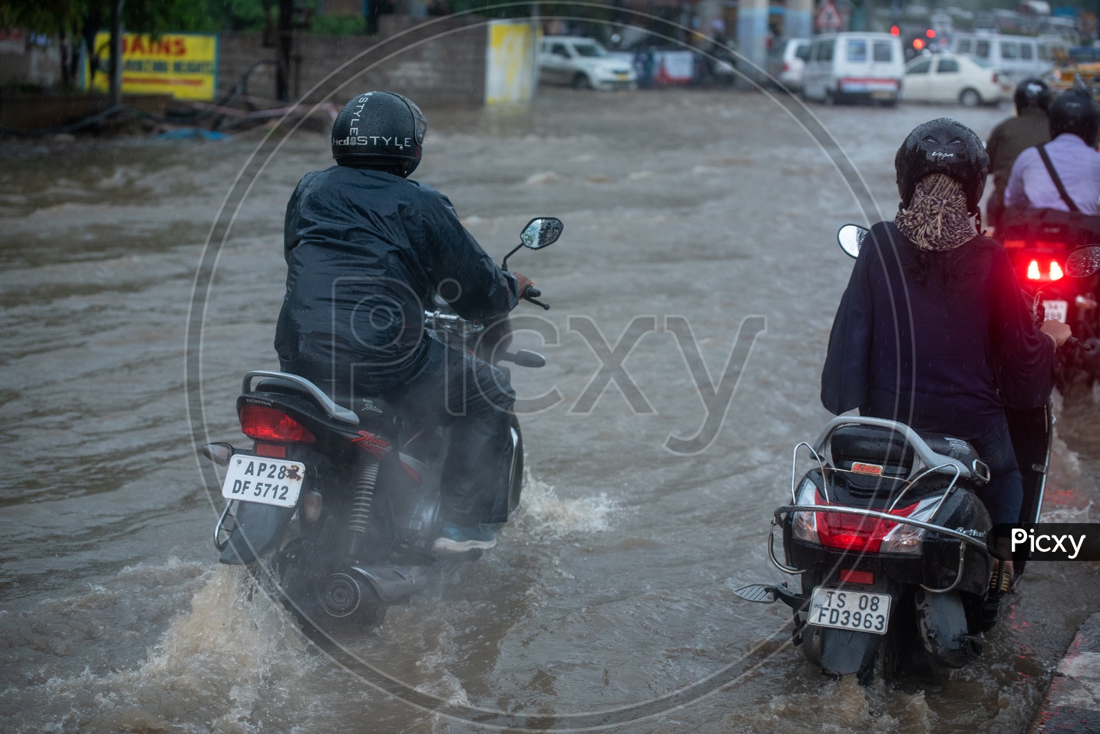 Commuters Struggles on Flooded Roads During Heavy Rain Near Hi Tech City
