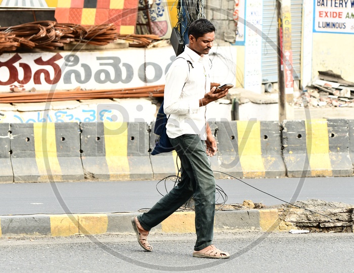 Indian Man walking along the road