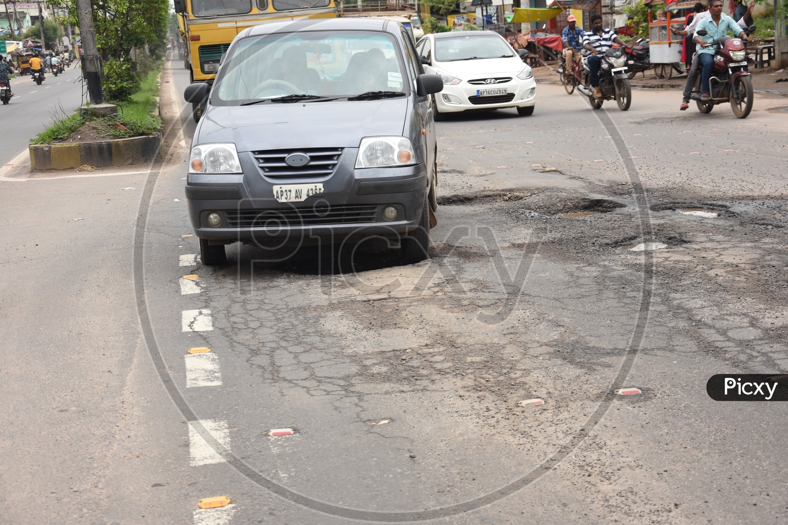 A Car moving on the damaged road due to Heavy rains in Vijayawada