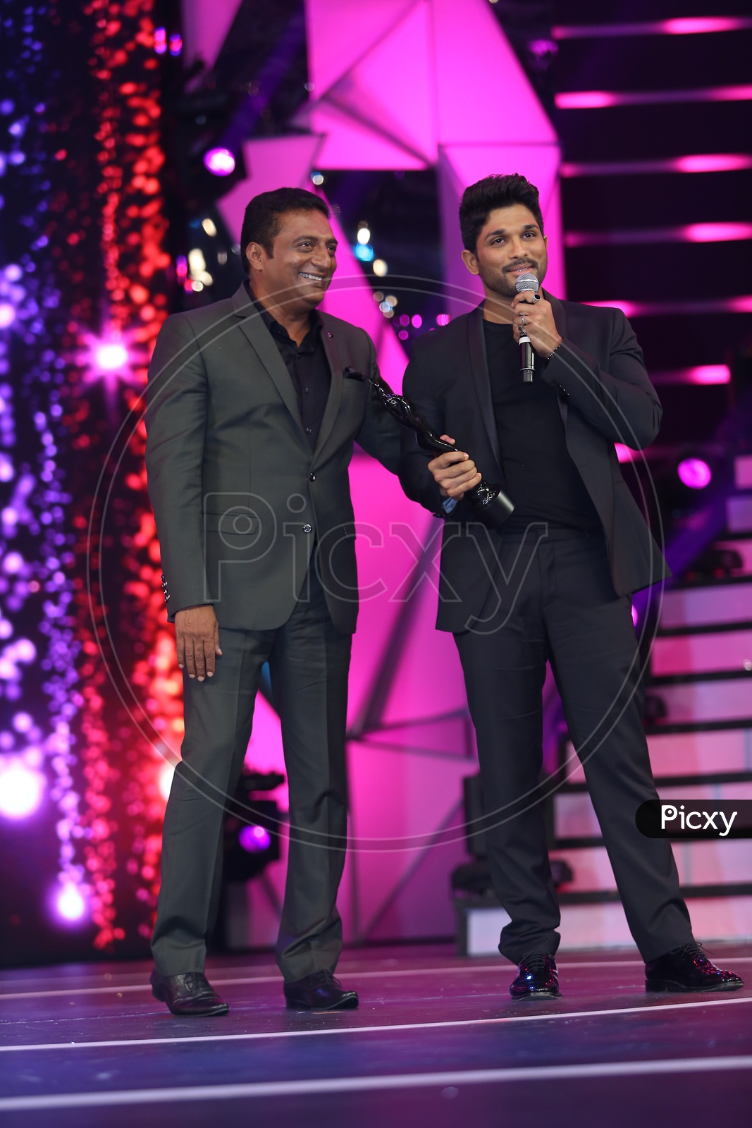 Tollywood Actor Allu Arjun speaking on the stage alongside Prakash Raj
