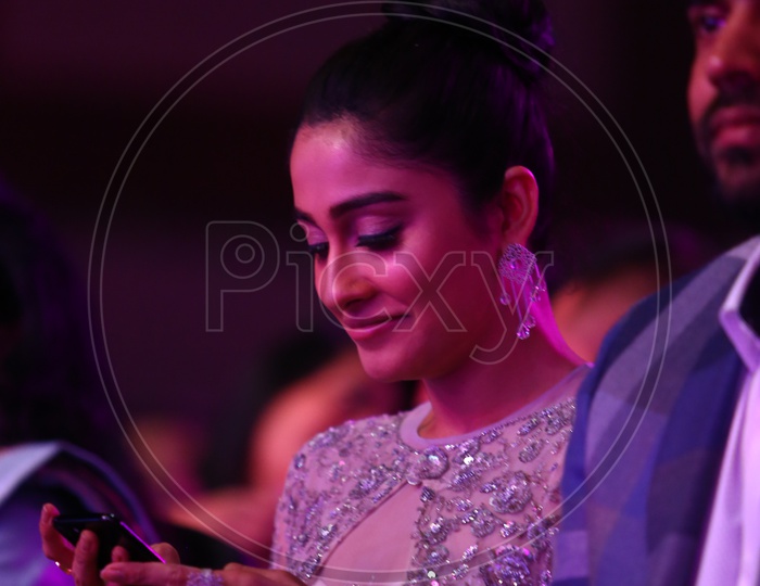 Tollywood Actress checking her phone during Filmfare Awards South 2017