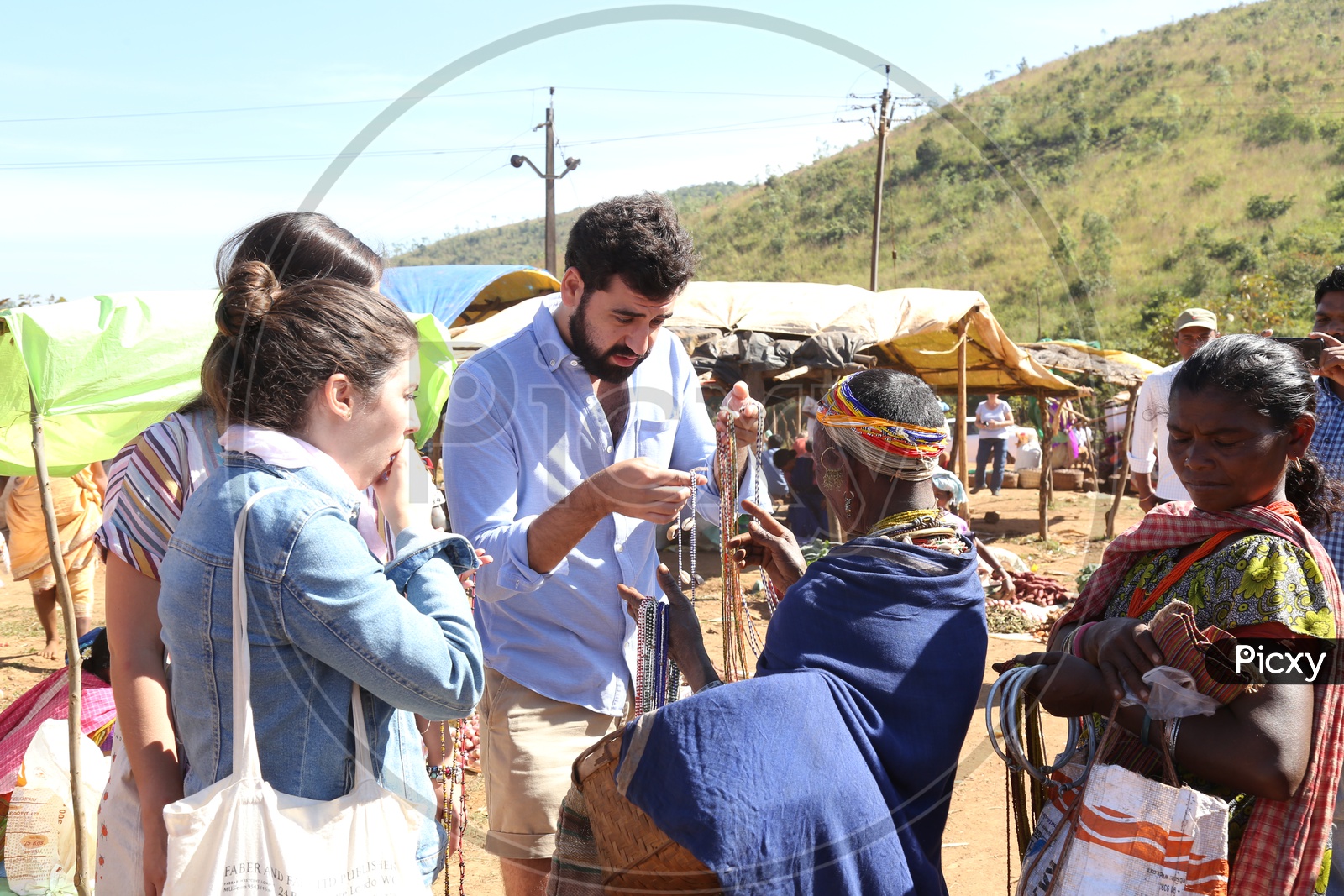 Foreigners Or tourists Purchasing Handmade Art Crafts  From Bonda Tribal Woman In tribal Village flea Market