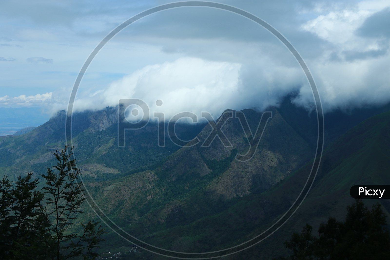 Landscape Of  Green Mountains Valleys With Trees And Fog Clouds in Munnar Ghat Roads