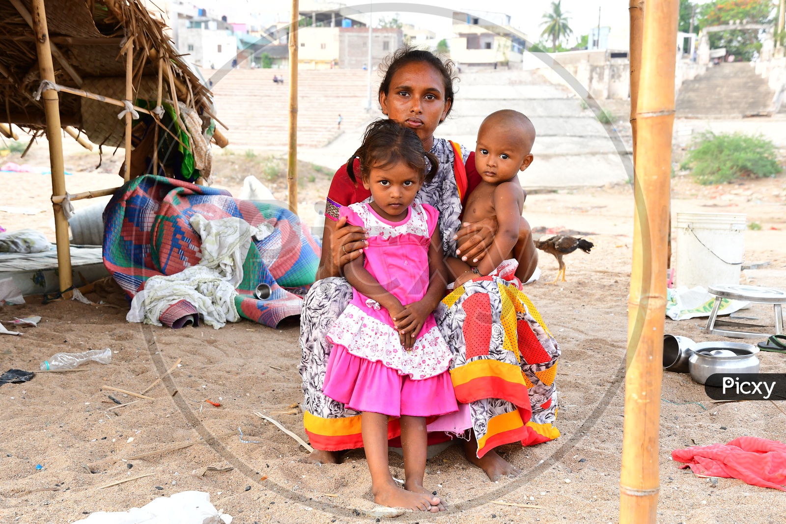 Indian Migratory Family Mother Along With Their Children At a Hut Made Of Plastic banners