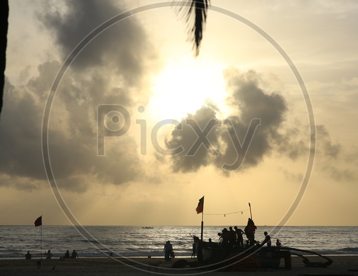 Silhouette of a Fishing Boat in A Beach With Sunset Sky in background