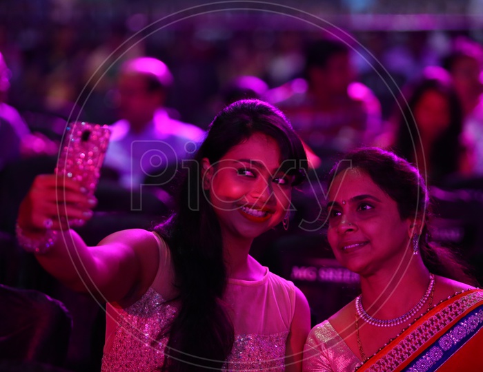 Young Indian Mother And Daughter Taking Selfies
