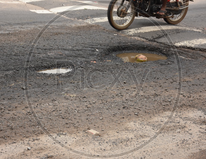Damaged Road With Potholes Due To Heavy Rains In Vijayawada