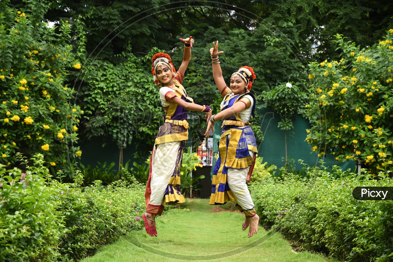 Indian Girls in a Traditional Dancer Attire jumping