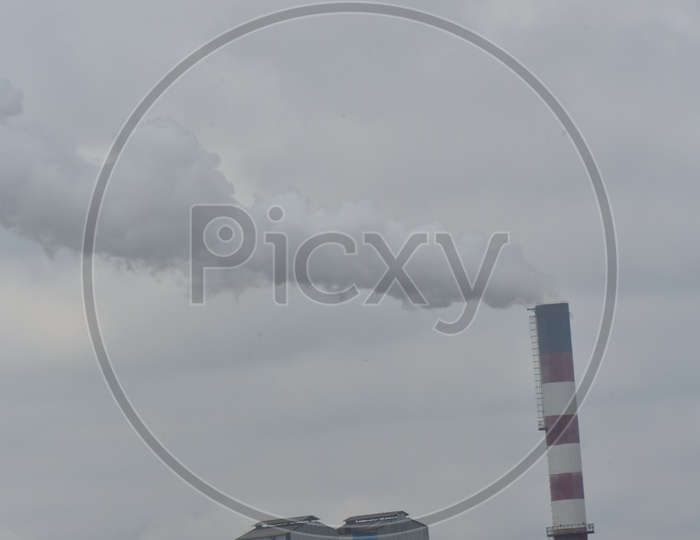 Thick Smoke Of an Industrial Pollution From an Exhaust Pipe over Sky Background