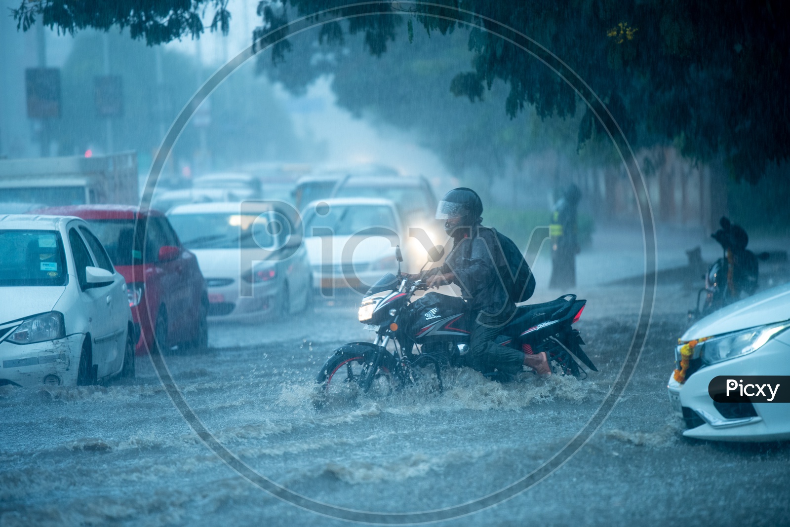 A Bike Commuter Riding In Flooded Road in Heavy Rain
