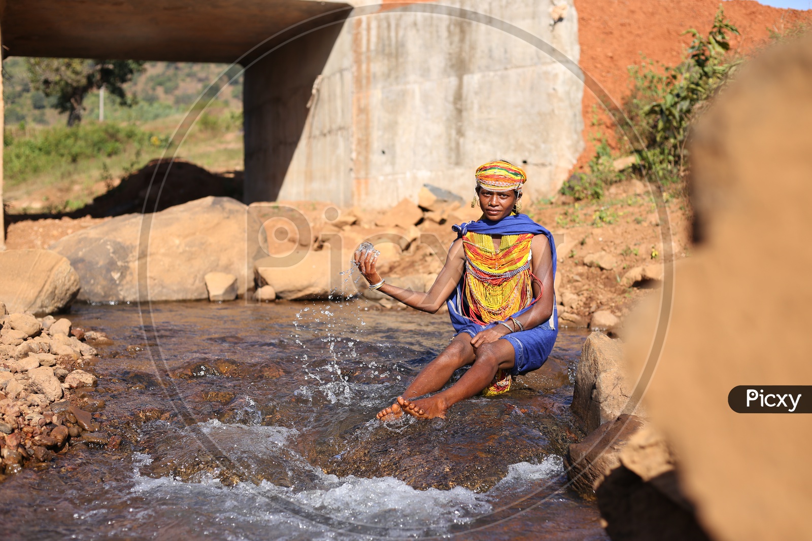 Bonda Tribal Woman Playing With Water At a Water Flowing Channel in a Tribal Village