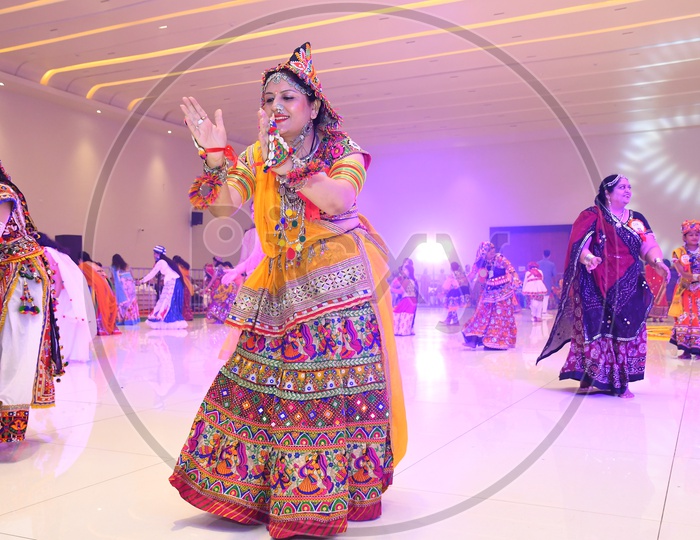 Beautiful Indian Girls Playing Dandiya Dance At Garba Dandiya Raas Event As a Part Of Durga Navratri Festivals