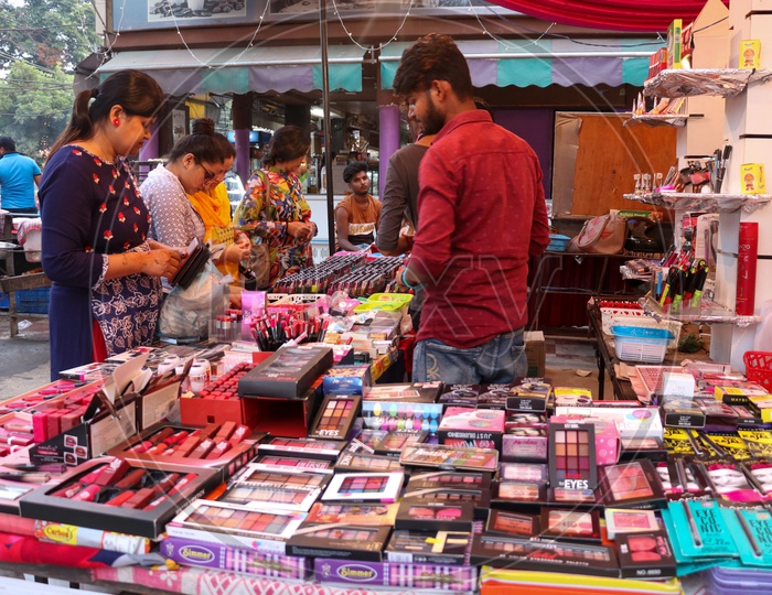 Women buying cosmetics at a stall in a market