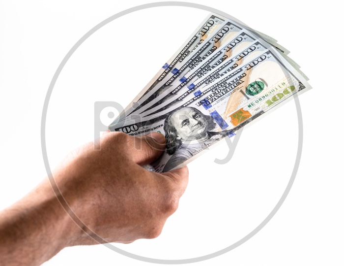 A Man Hand Holding US 100 Dollar Bills Or Currency Notes in Hand Closeup Over an Isolated White Background