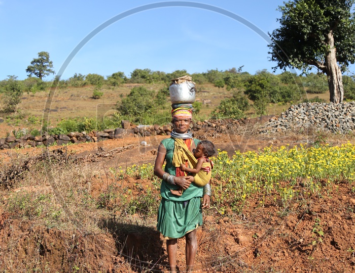 Bonda Tribal Woman With Her Child In Tribal Village Agricultural Fields at Andhra Odisha Border