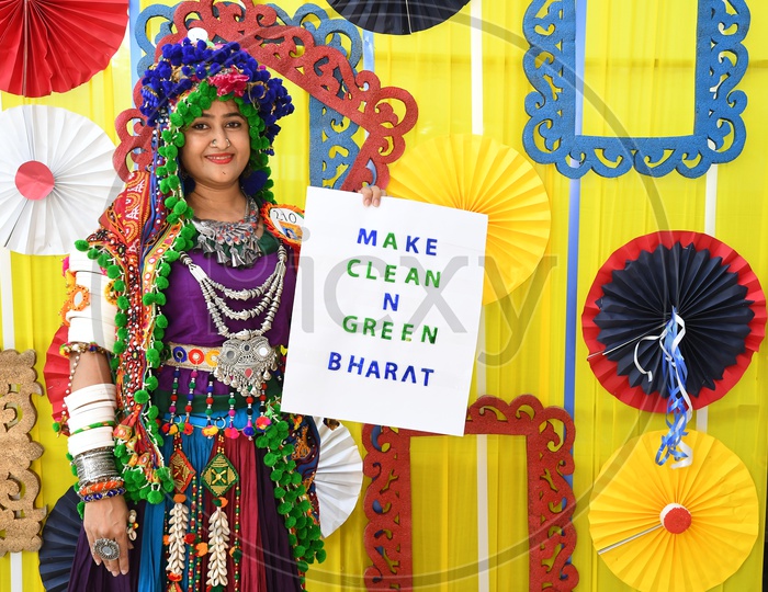 Beautiful Indian Woman in Traditional Wear At Garba Dhandiya Raas Event With Cleanliness Awareness Placard