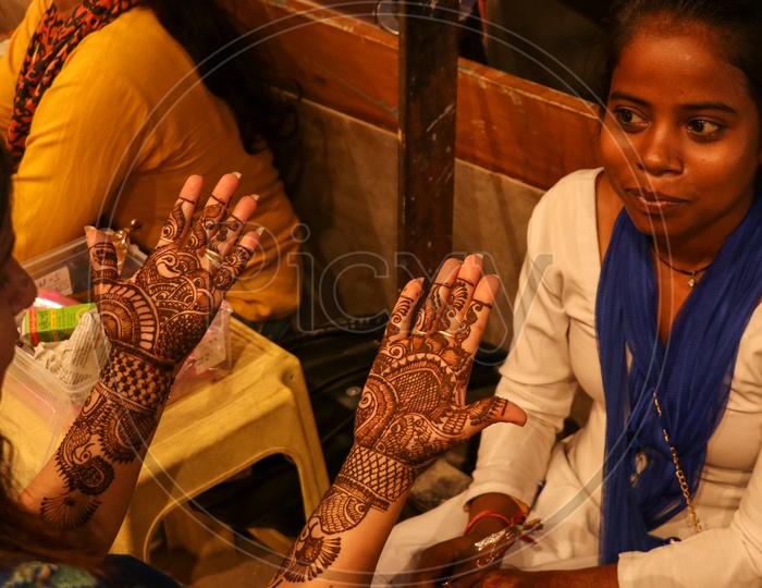 Mehandi design on a woman's hands