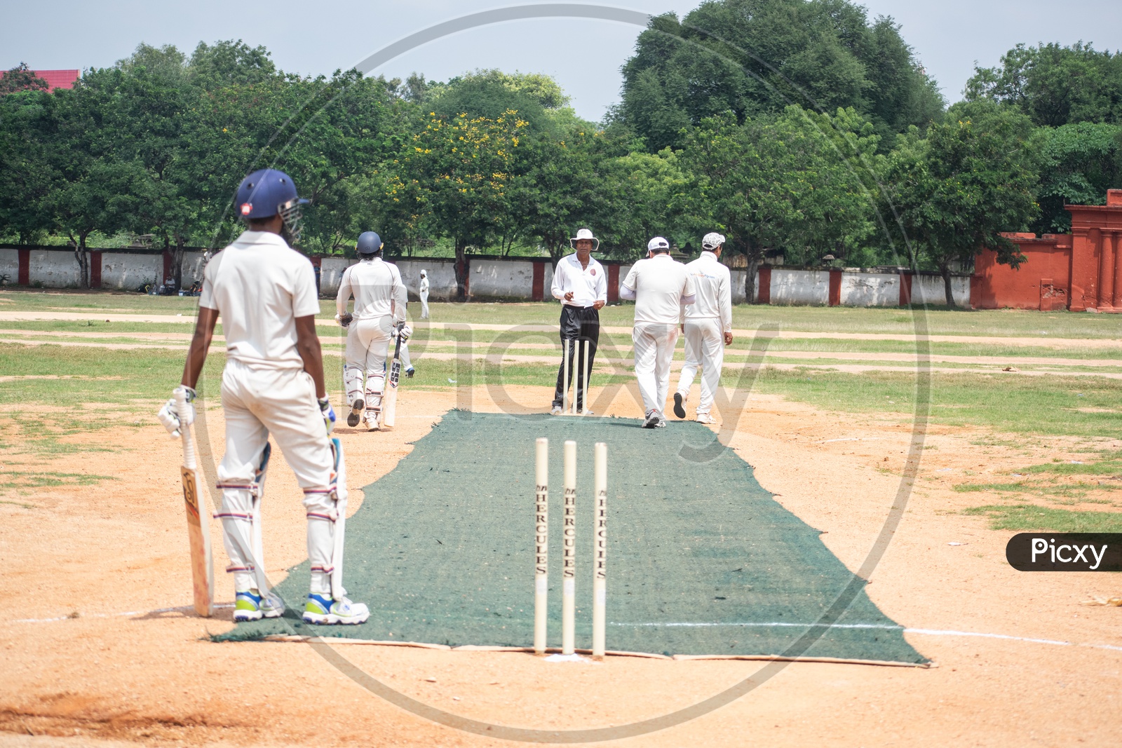 Cricket Players Playing Cricket In a Ground
