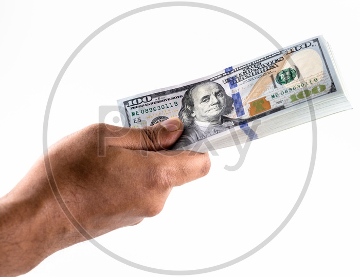 A Man Holding US Hundred Dollar Bills  or Currency  Bundle  in Hand On an Isolated White Background