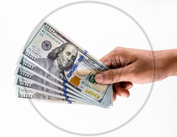 A Man Holding US Hundred Dollar Bills  or Currency  in Hand On an Isolated White Background