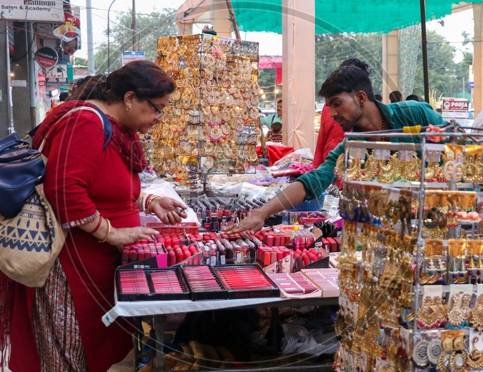 Woman Shopping Cosmetics At a Stall