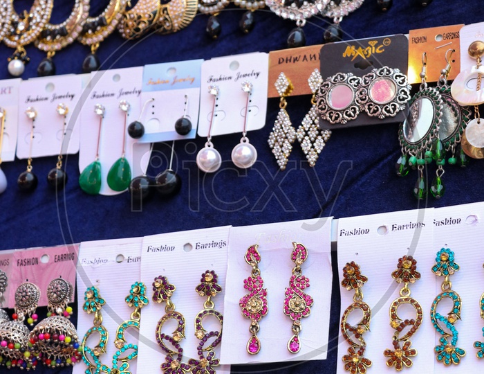 Various Designs Of Ear Tops In Display At a Stall