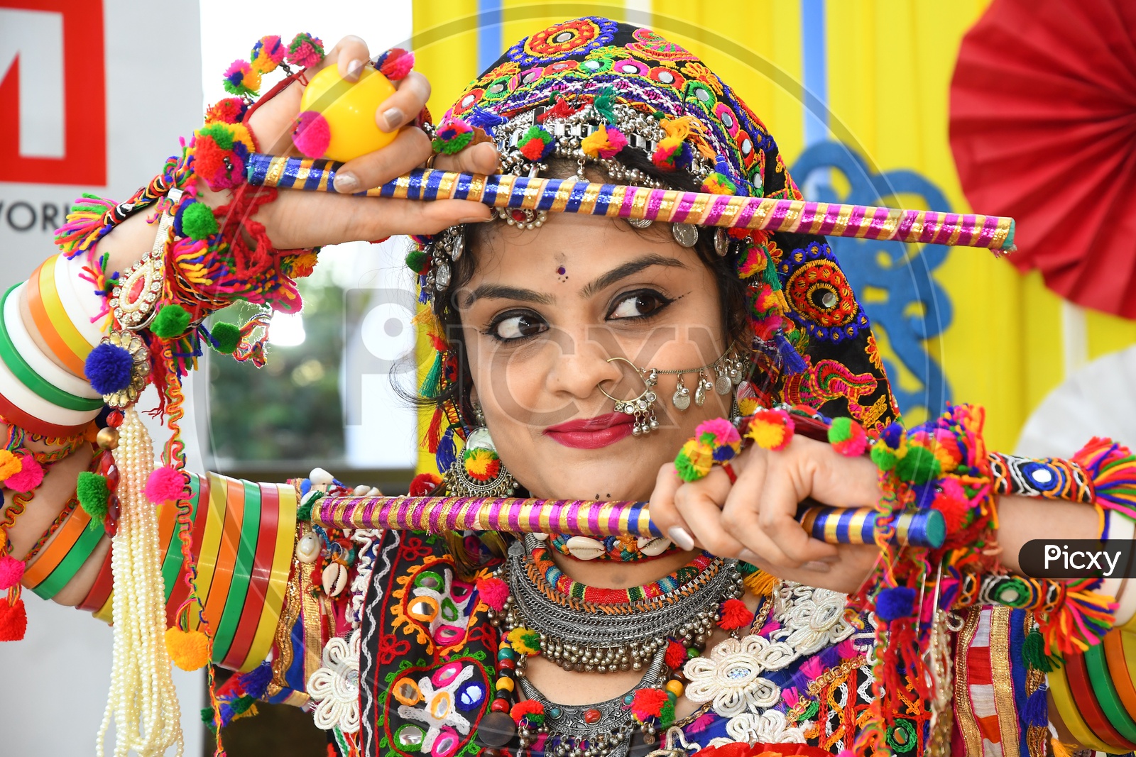 Back view of Indian woman dancing with dandiya stick. 27617538 Vector Art  at Vecteezy