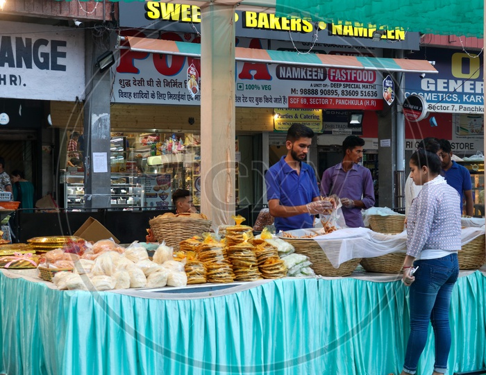 A vendor selling sweet and confectionories at a stall