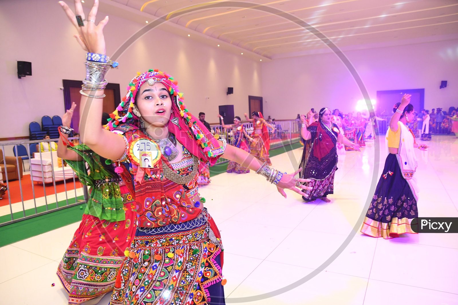 Beautiful Indian Girls Playing Dandiya Dance At Garba Dandiya Raas Event As a Part Of Durga Navratri Festivals